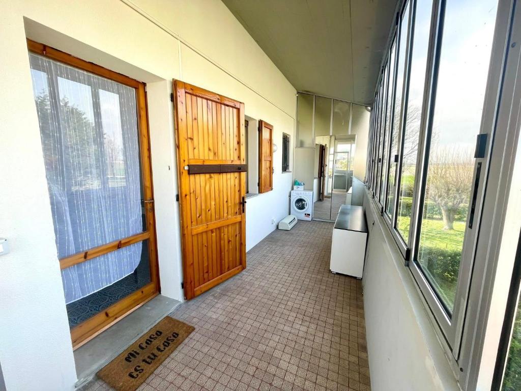a hallway of a building with a door and windows at Casa Ariel in Lido Adriano
