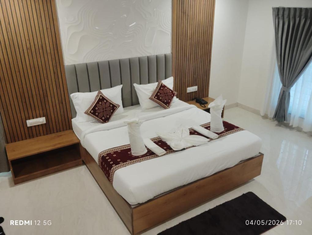 a bedroom with a bed with pillows on it at hotel ananth inn in Mahālingpur