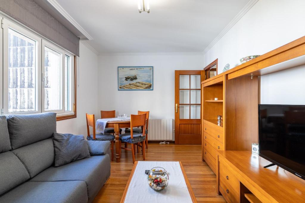 a living room with a couch and a table at Apartamento Río do Con Vilagarcía in Vilagarcia de Arousa