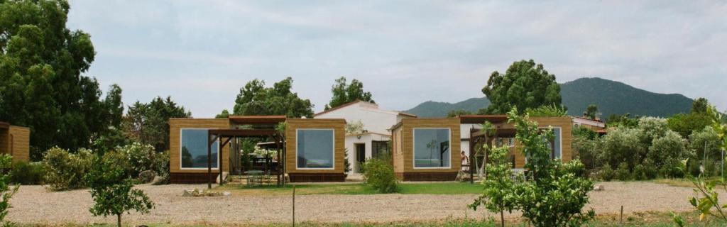 a house in the middle of a field at Macondo Agriliving Tiny Houses in Castiadas