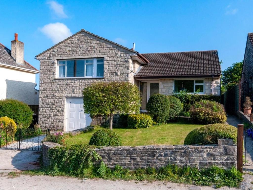a brick house with a white garage at 2 Bed in Wareham oc-75483 in Corfe Castle