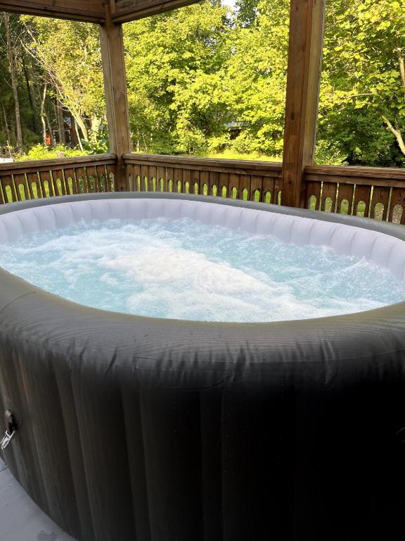 a hot tub in a gazebo at Stor villa med jacuzzi in Herräng