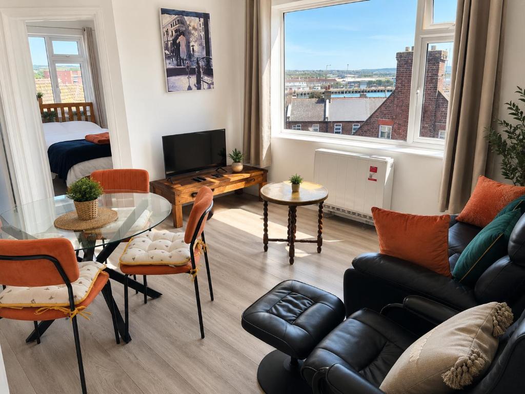 a living room with a couch and a table at 2BR Mariners Stay - Newhaven in Newhaven