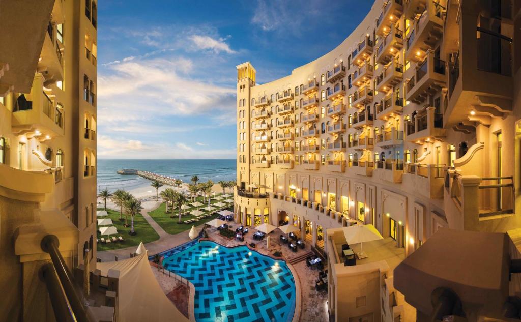 an aerial view of a hotel with a swimming pool at Bahi Ajman Palace Hotel in Ajman 