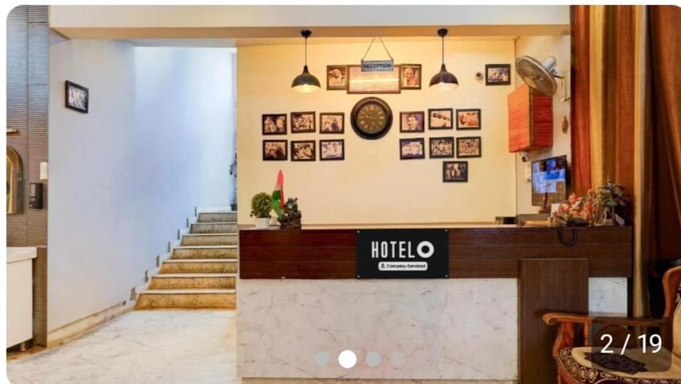 a lobby of a hotel with a reception desk and stairs at hotel gsa & guest house in Haridwār