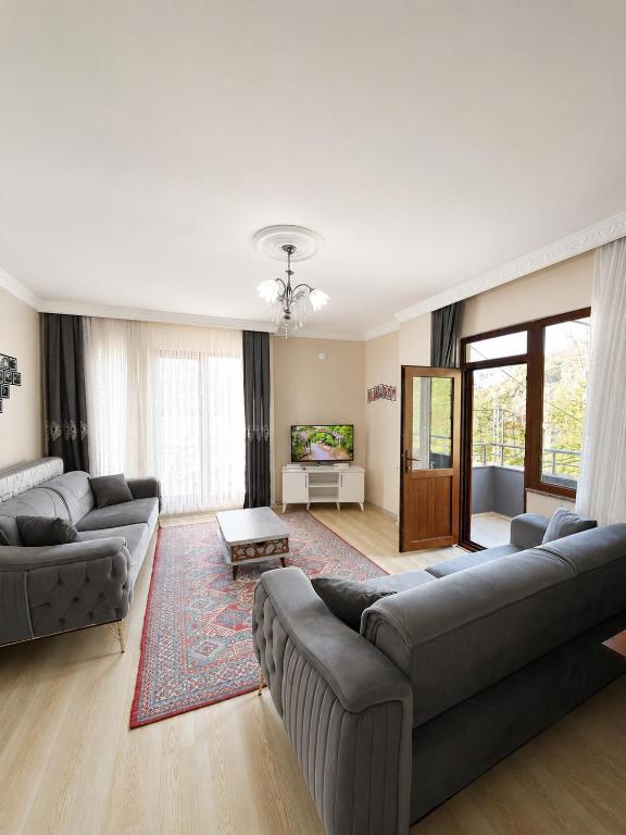 a living room with two couches and a table at Rize Akarsu Apart in Rize