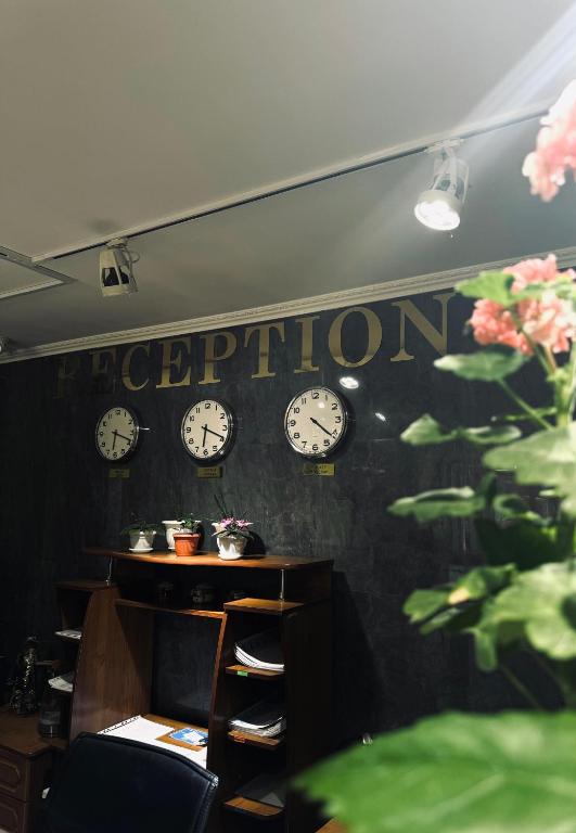 a room with clocks on the wall at Отель Бестау in Aksay