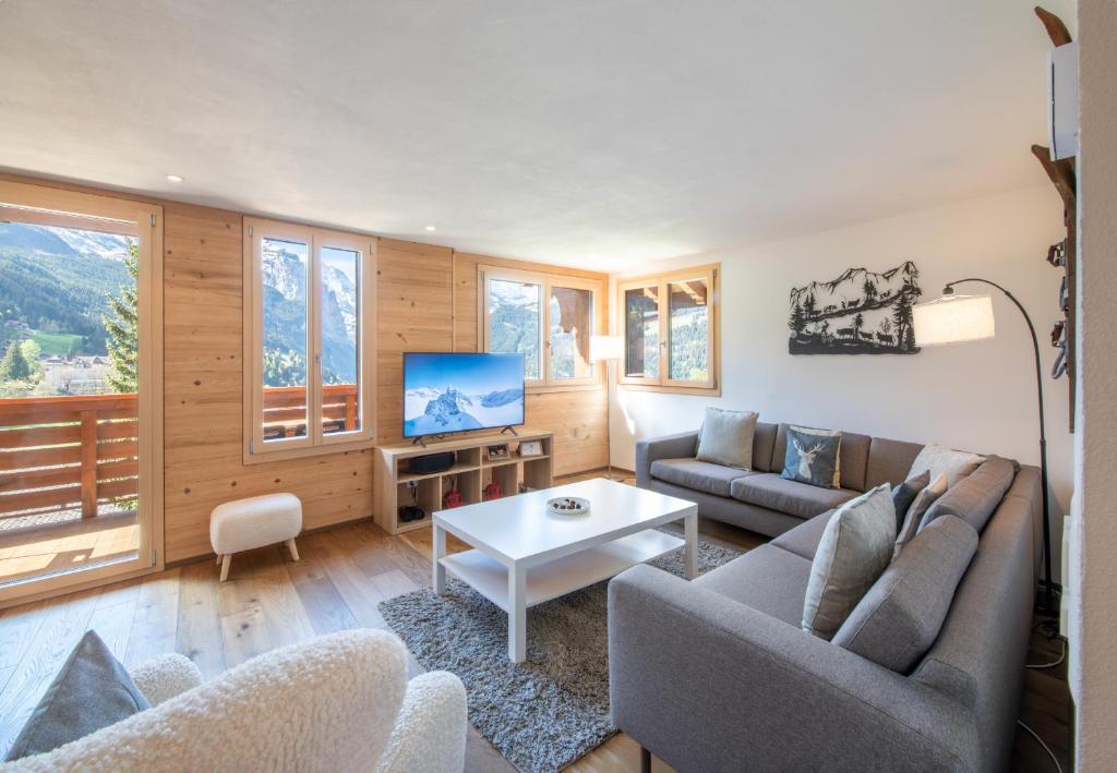 a living room with a couch and a table at Chalet Rubi in Wengen