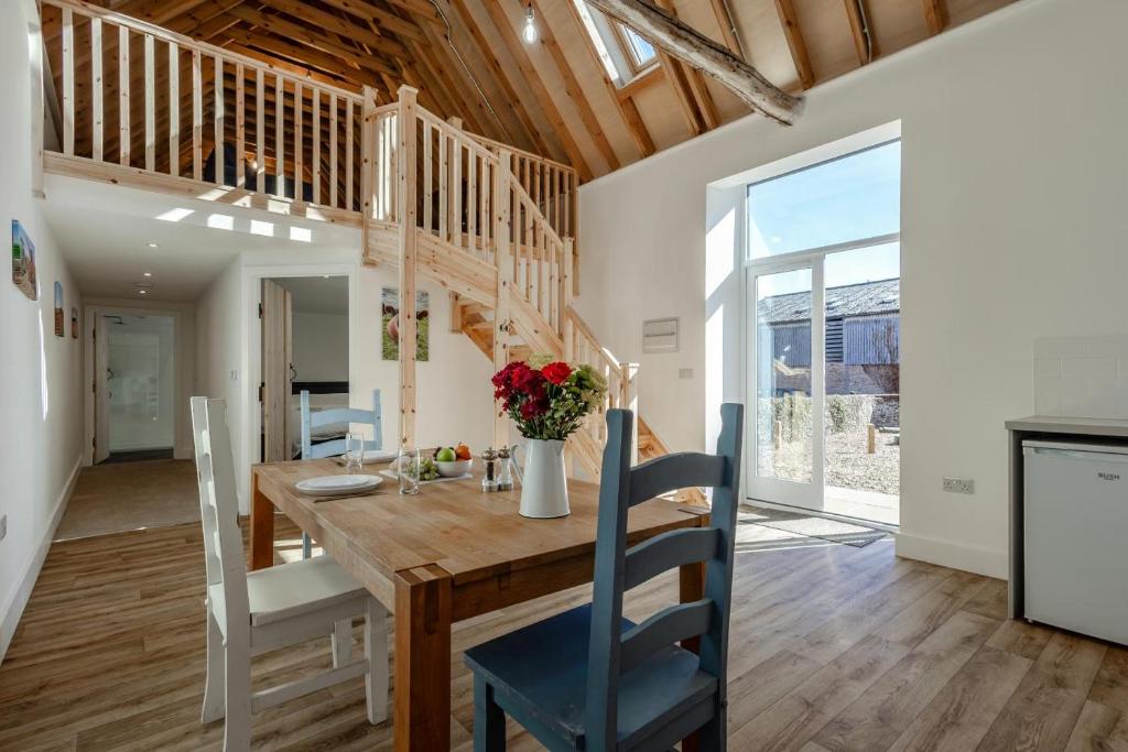 a kitchen and dining room with a wooden table and chairs at 1 Bed in Barrow oc-b42640 in Barrow