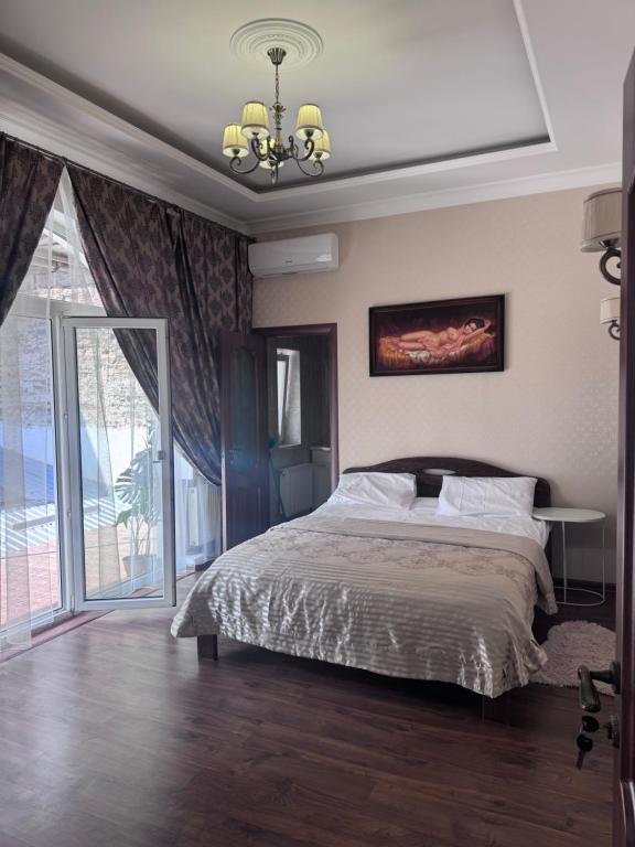 a bedroom with a bed and a large window at Liders17 in Odesa