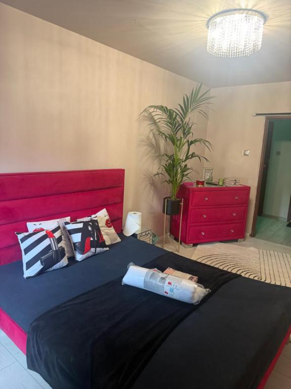 a bedroom with a large bed with a red headboard at Krakowska in Tarnów
