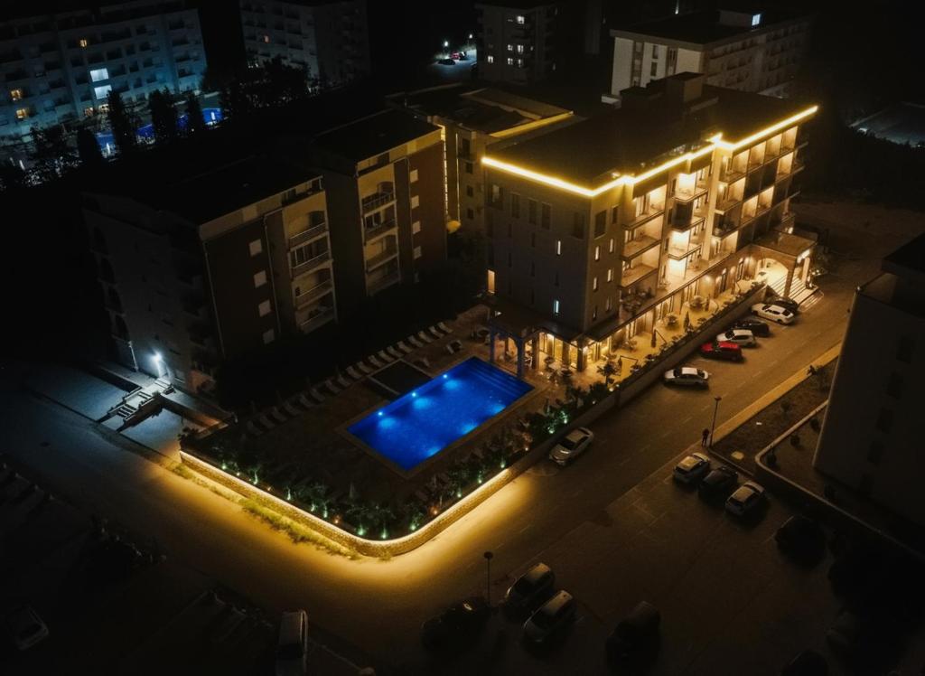 an overhead view of a building with a swimming pool at night at Uma Premium in Ulcinj