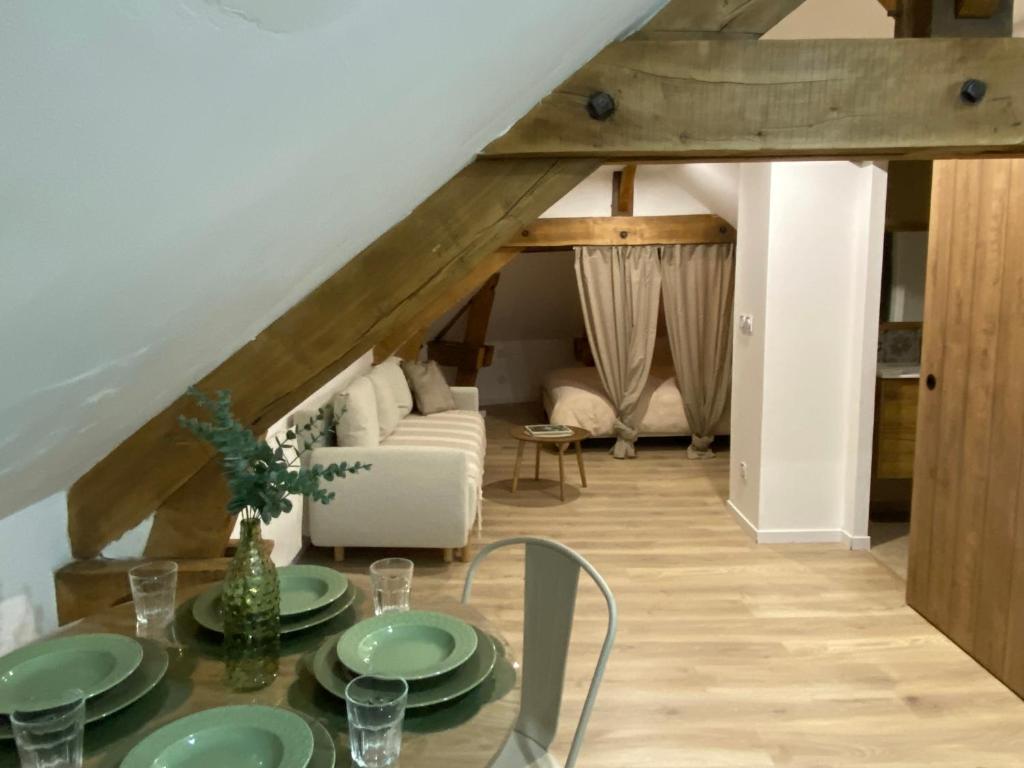 a living room with a table and a couch at Amelia in Saint-Aignan