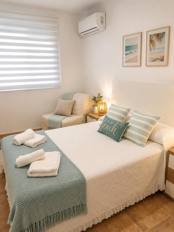 a bedroom with a large bed with towels on it at Mar azul in Puerto de Mazarrón