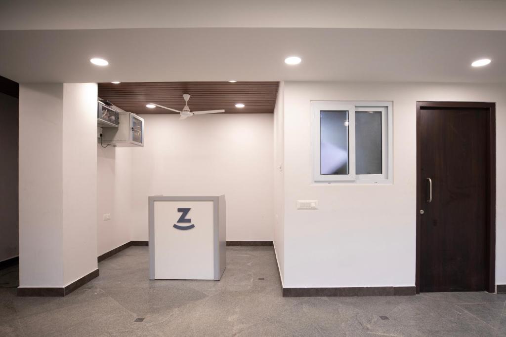 an empty room with a door and a room with a sign at Z Express Anoop in Bangalore