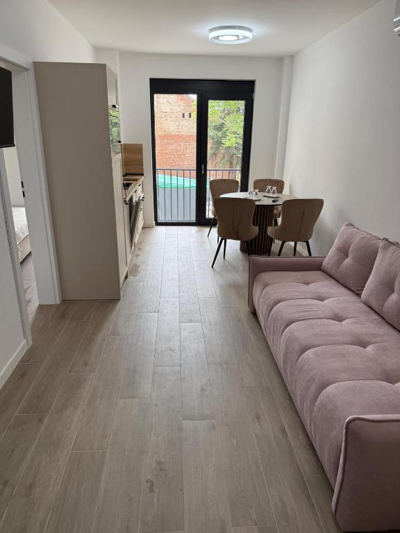 a living room with a couch and a table at Aria & Boris Apart Kogalniceanu in Oradea