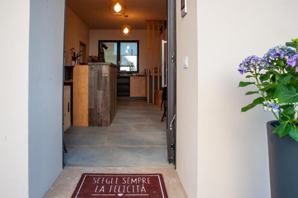 a hallway of a house with a sign on the floor at Bastian B&B in Sarmede