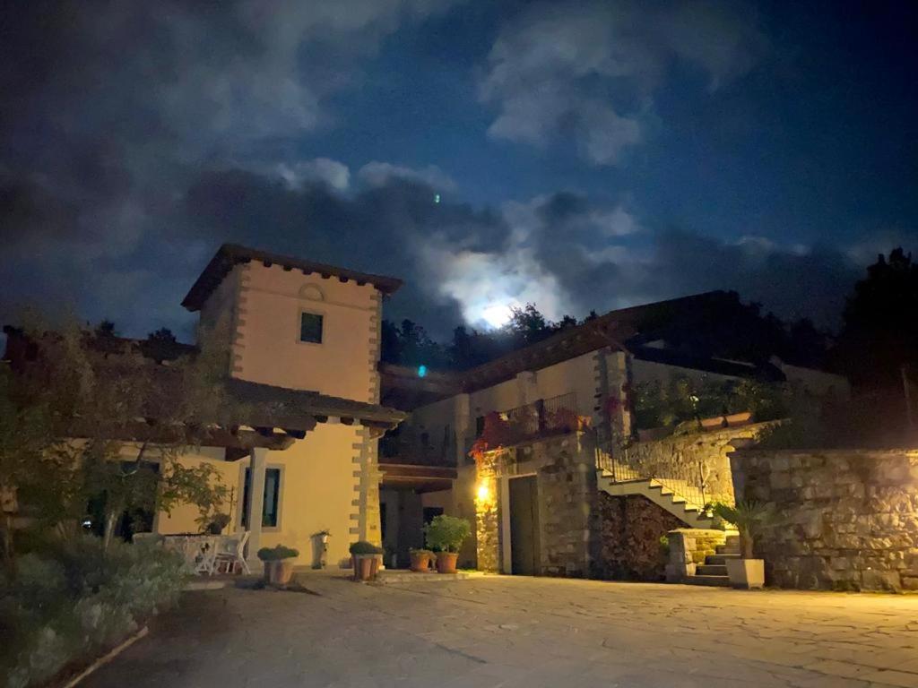 a building at night with a moon in the sky at Podere Caselina b&b in Camugnano