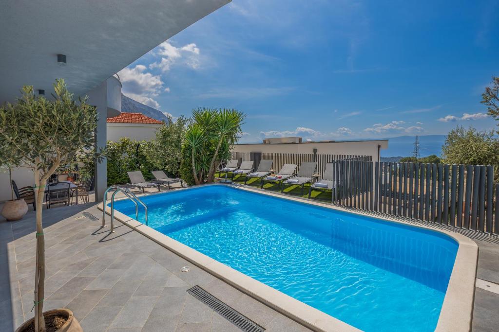 a swimming pool on top of a building at Villa Collis in Makarska