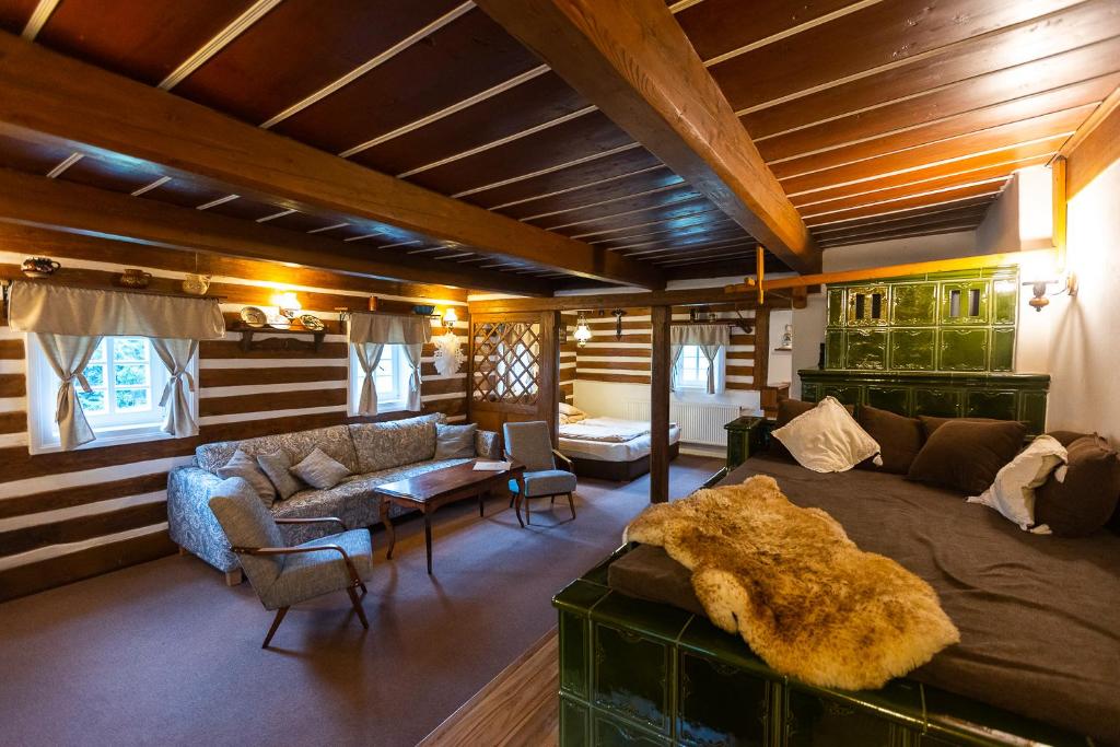 a living room with a large bed and a couch at Cibulka in Horní Malá Úpa