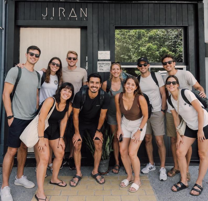 a group of people standing in front of a building at Jiran Hostel Kota Kinabalu in Kota Kinabalu