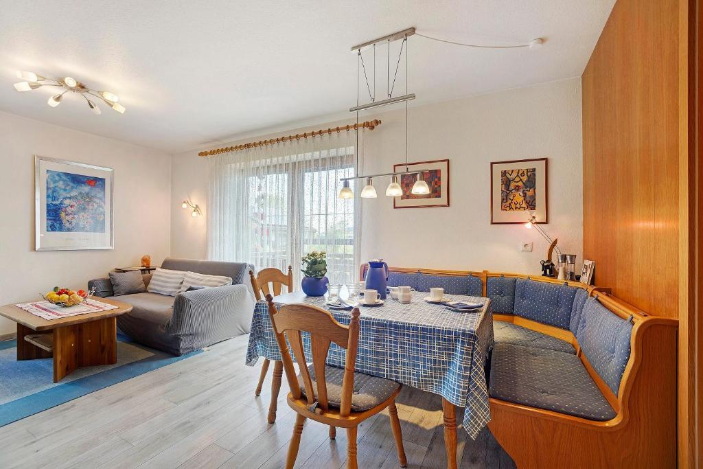 a living room with a table and a couch at Ferienwohnung Vogel in Wertach