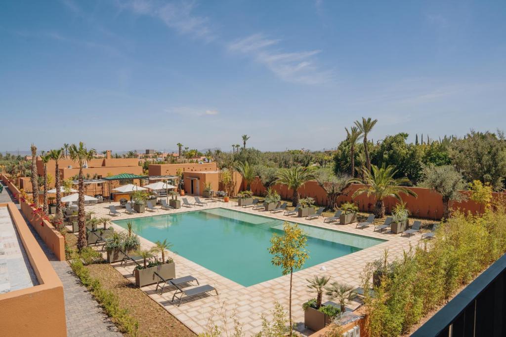 a swimming pool with lounge chairs and a resort at TRIANON Résidence Hôteliere in Marrakesh