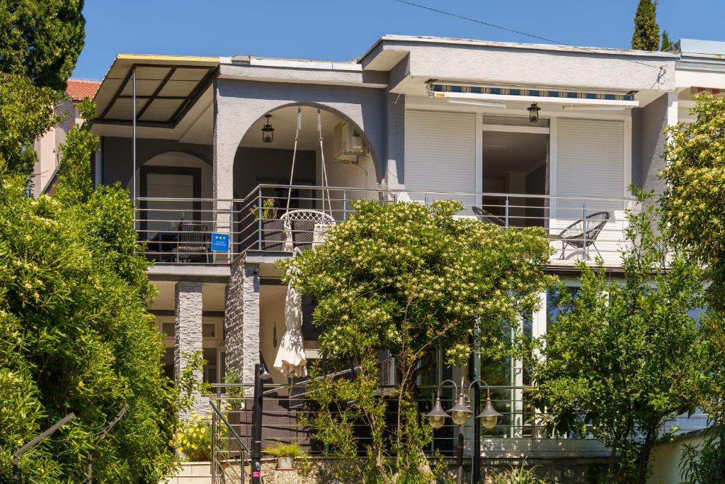 a large white house with a balcony at House Goran in Crikvenica