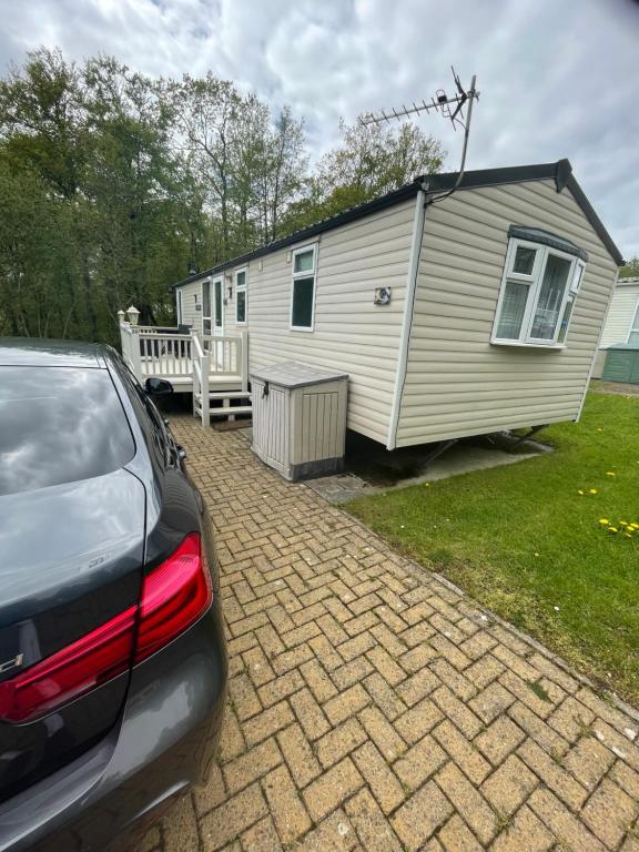 a car parked in front of a tiny house at 38 the pines in Newton on the Moor