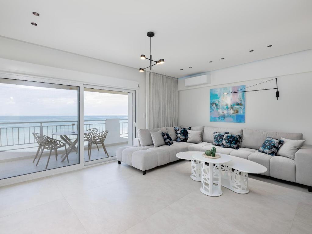 a living room with a couch and a table at Ciel Collection - Luxury Seafront Living in Perea