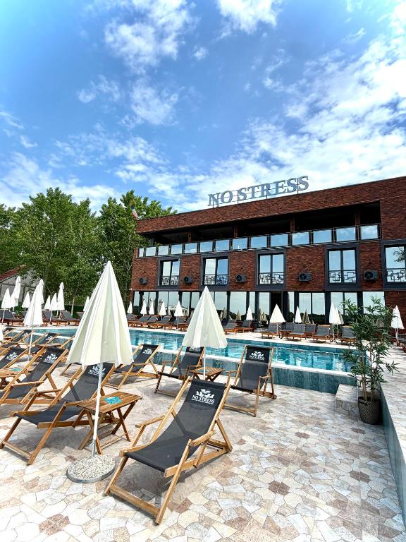 a group of lounge chairs next to a swimming pool at No Stress in Borča