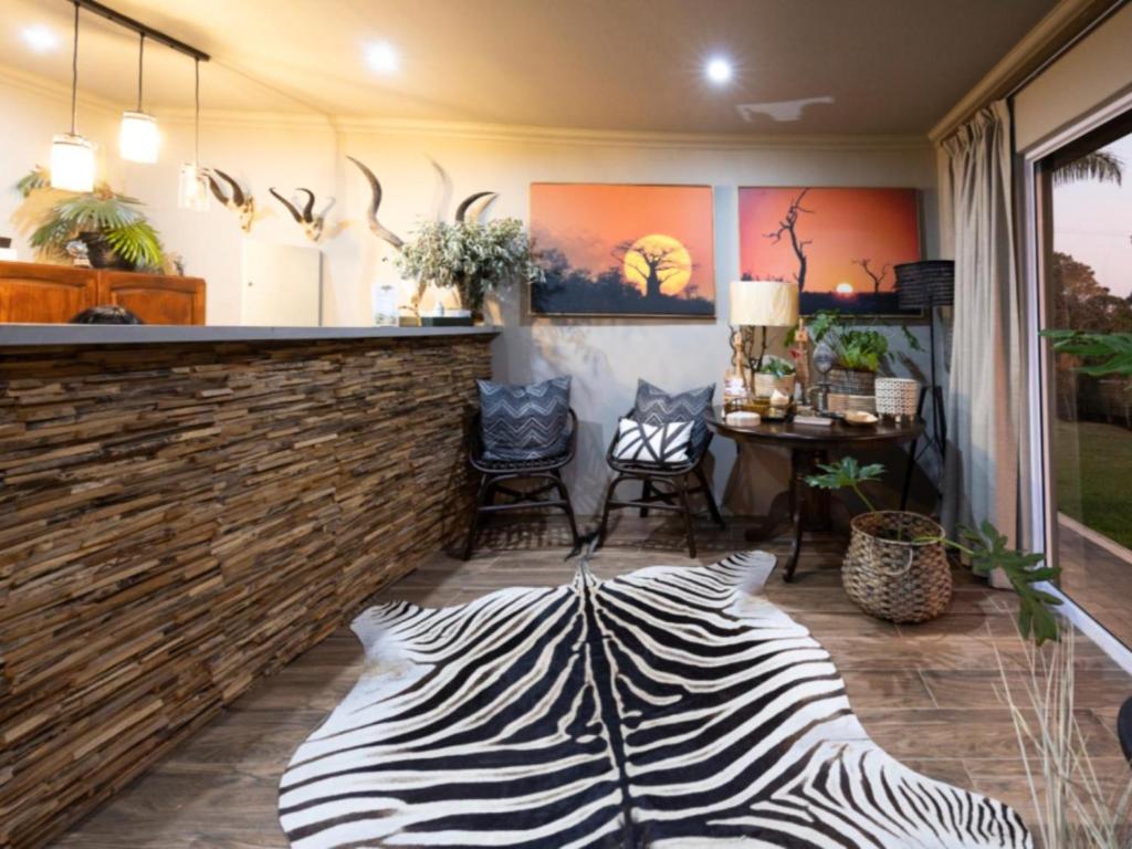 a zebraebra rug sits in the middle of a bar at Fever Tree Self Catering in Hillcrest