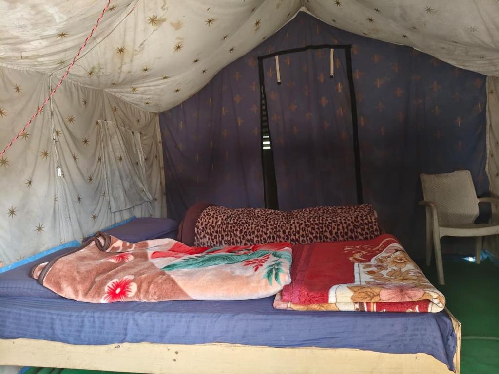 a bedroom with a bed in a tent at HIMALAYAN ESCAPE CAMP chopta in Chopta