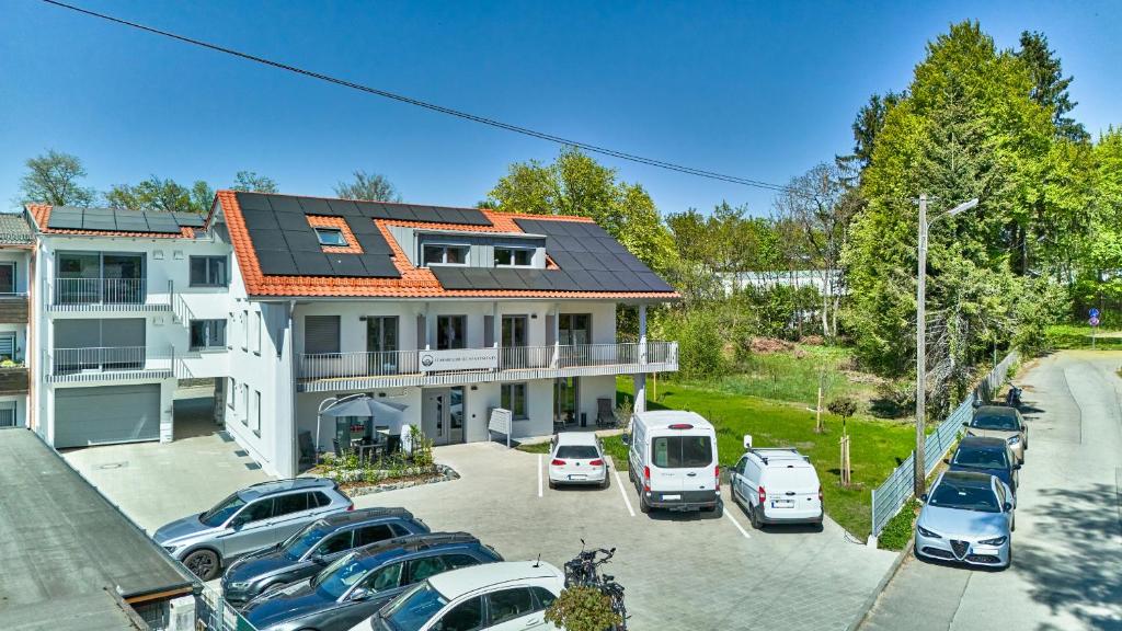 a parking lot with cars parked in front of a building at Starnberger See Apartments in Starnberg