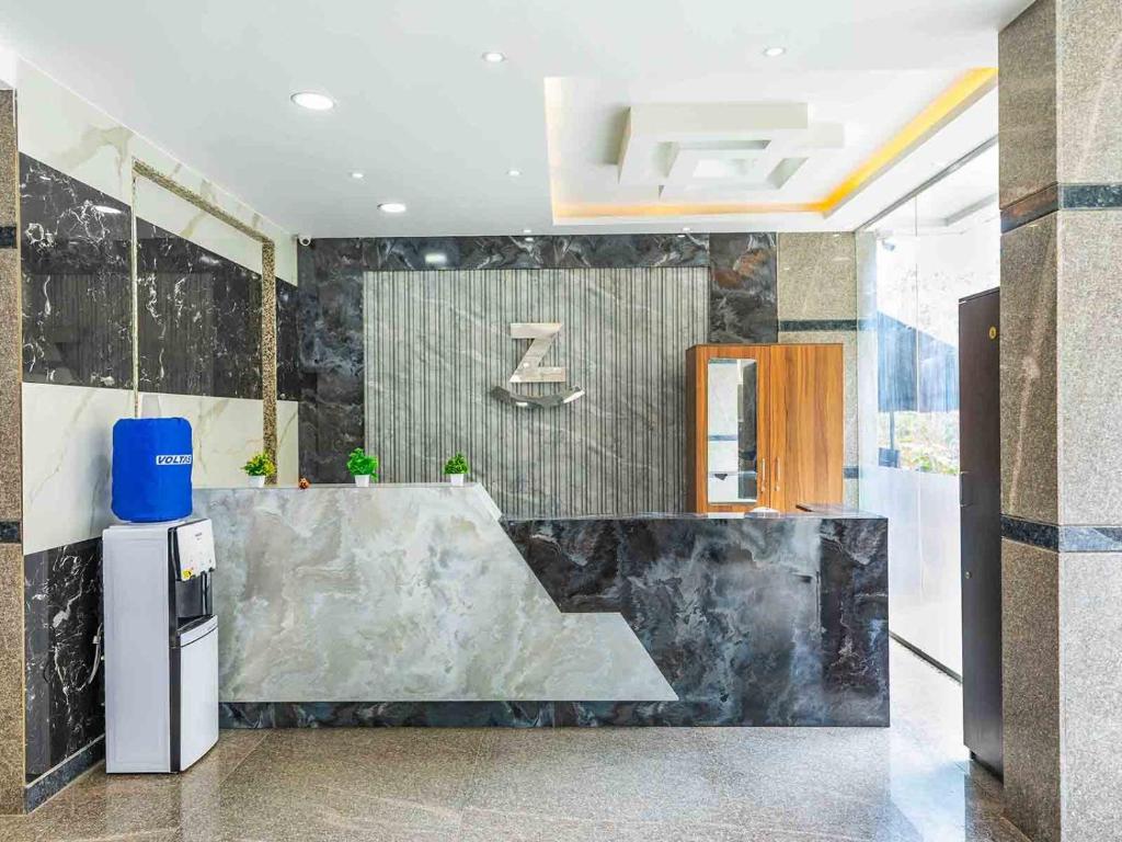 a lobby with a large marble counter in a building at Z Express Aradhana in Bangalore