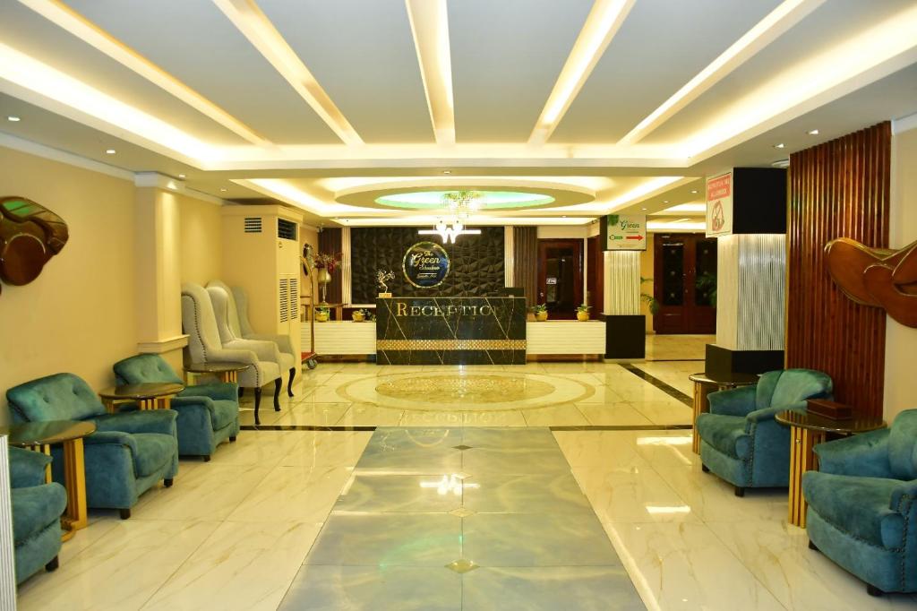 a lobby with blue chairs and a waiting room at The Green Shadow Business Hotel in Chittagong
