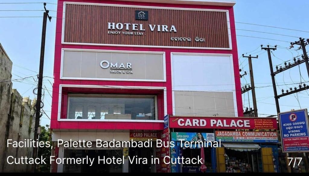 a large red building with a sign on it at Hotel Vira in Cuttack