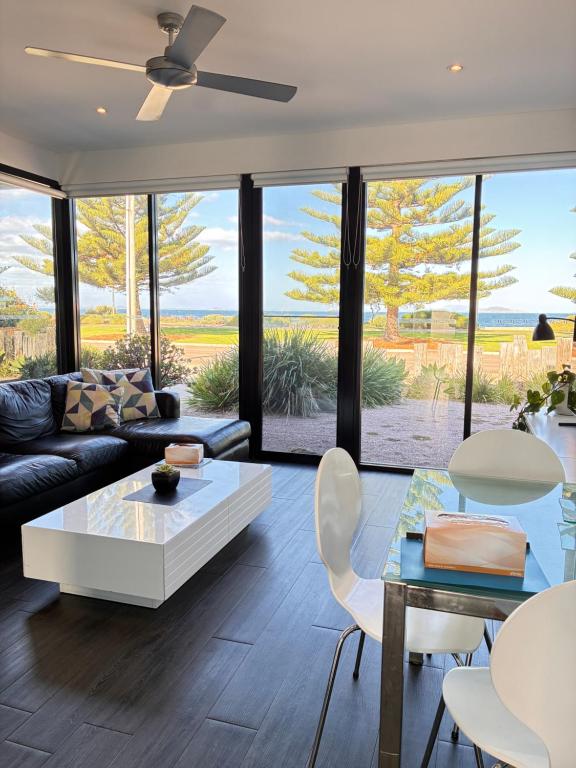 a living room with a couch and a table at Esperance Waterfront Apartment in Esperance