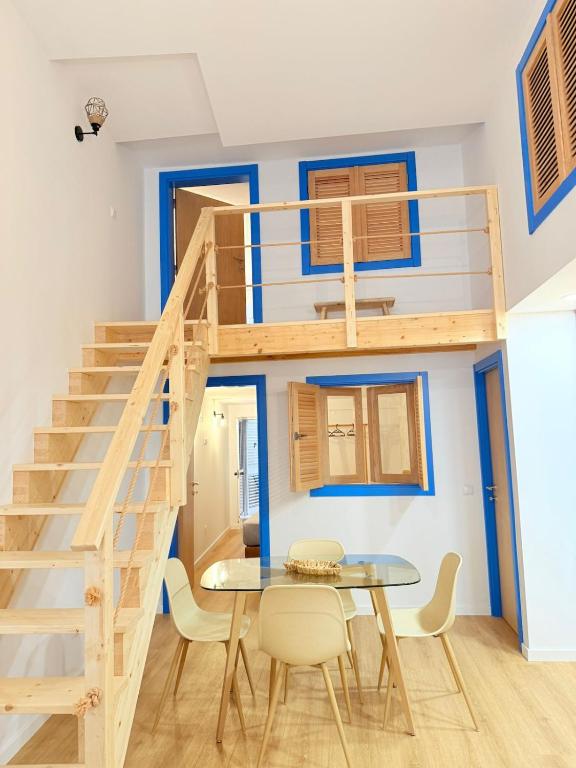 a tiny house with a staircase and a table at Casa Trainêra in Nazaré