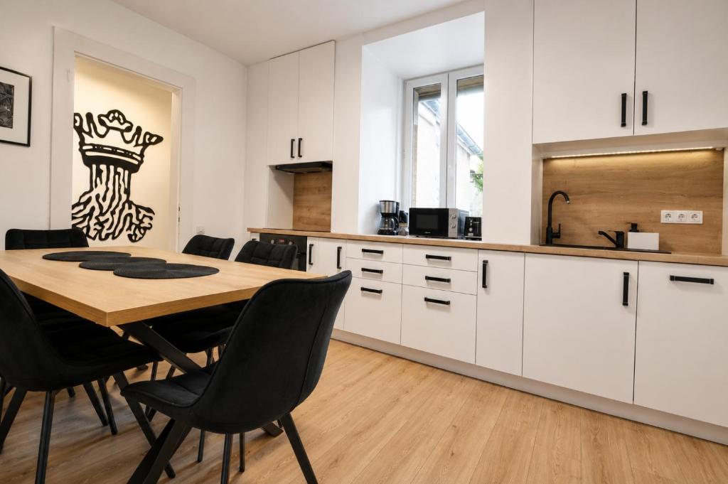 a kitchen and dining room with a table and chairs at Luxurious & Spacious Residence in the Heart of Brașov in Braşov
