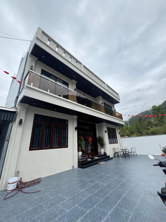 a building with a patio with tables and chairs at Dũng Đậu Homestay in Hai Phong