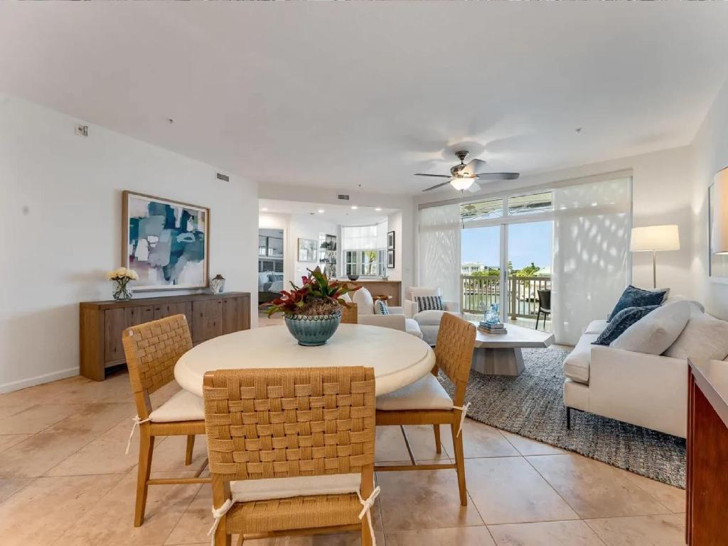 a dining room and living room with a table and chairs at Elegant Waterfront Corner Residence in Key West