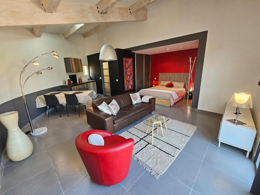 a living room with a couch and a bed at Loft Casa Couderc Terrace Parking in Velaux