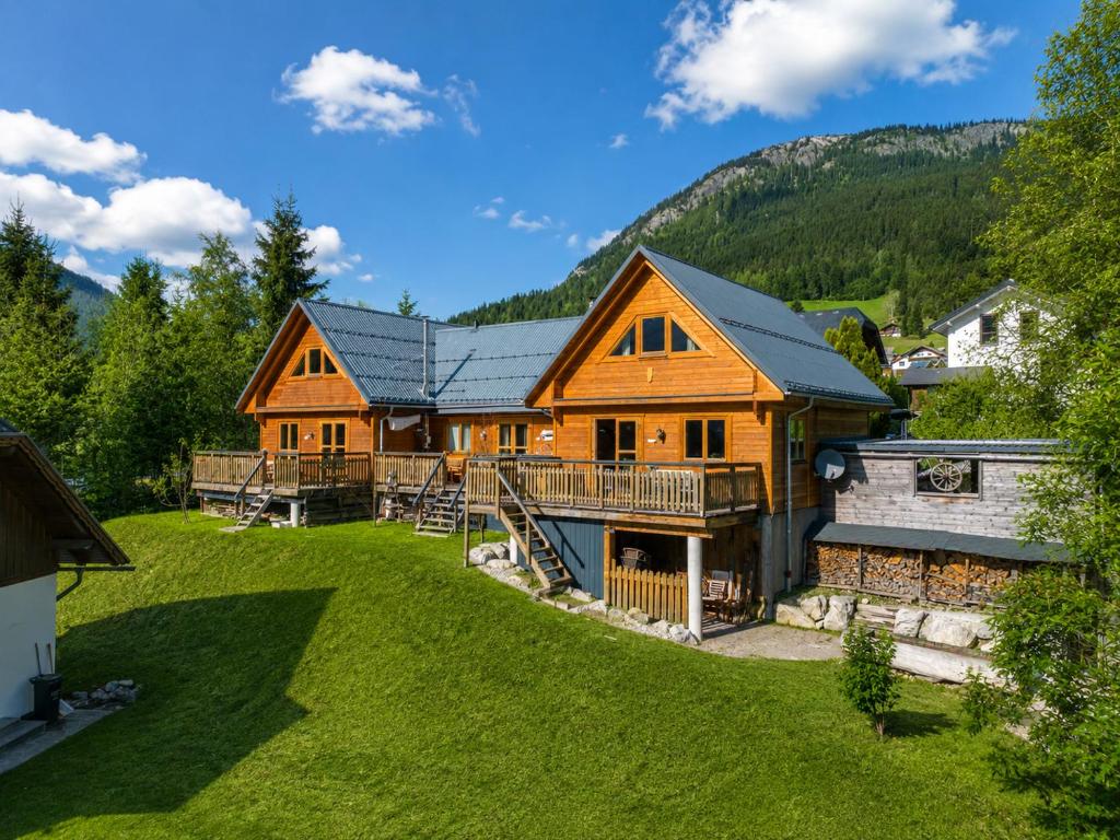 an image of a log home with a yard at Alpen Chalets Ausseerland - Sauna & BBQ in Bad Mitterndorf