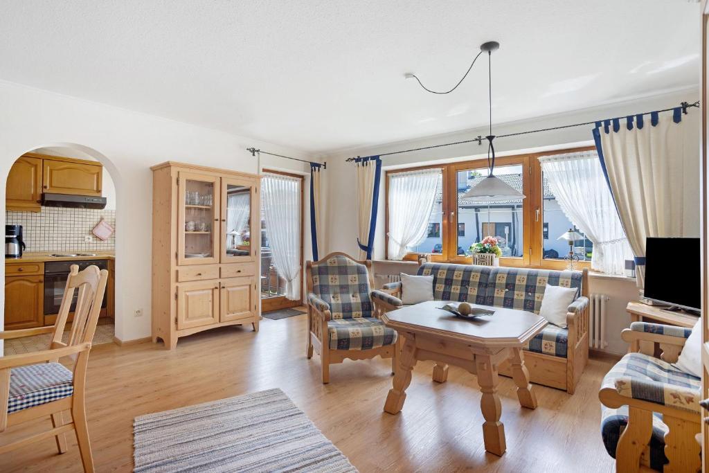a living room with a couch and a table at Haus Grüntensee in Wertach
