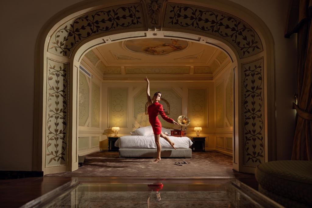 a woman in a red dress dancing in a bedroom at Sonesta Hotel Tower & Casino Cairo in Cairo