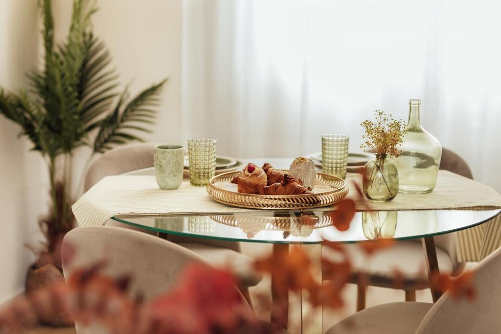 a glass table with a plate of food on it at Castros Homes in Santander