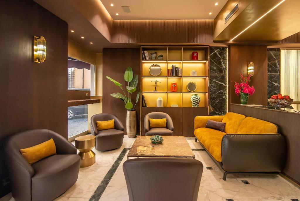 a living room with a couch and chairs and a table at Hotel Accademia in Rome