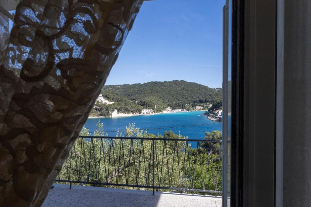 a view of a beach from a window at Sea View apartment 50 m from St Rok Beach in Pučišća