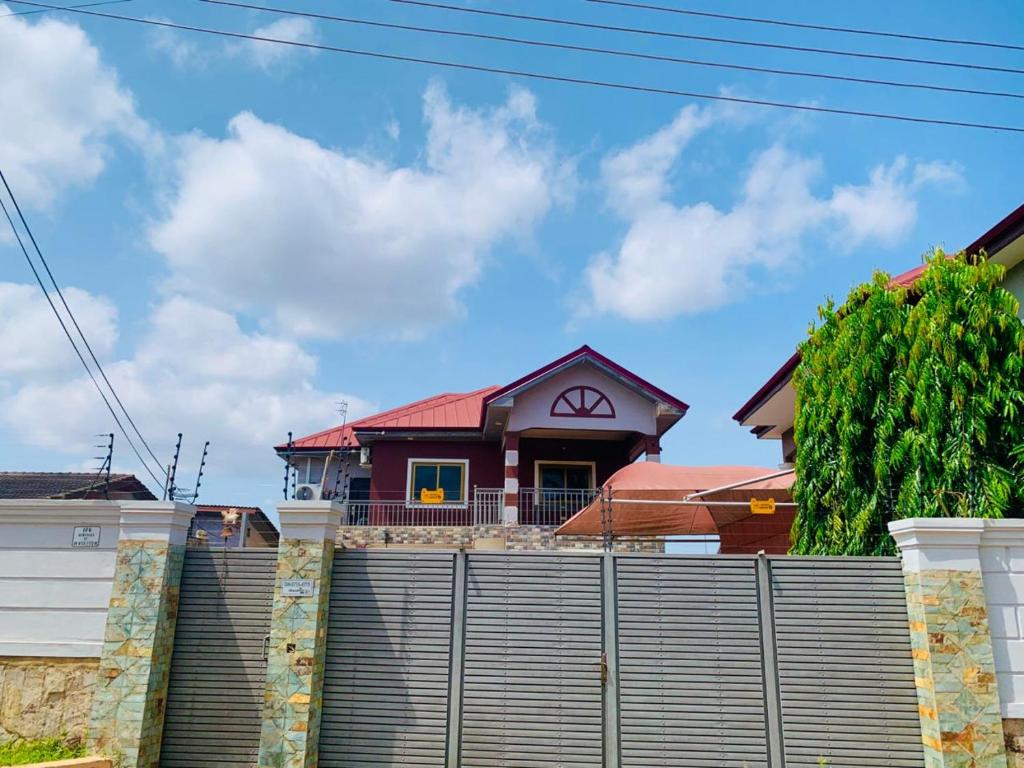 a house behind a fence at AB Home Suites in Asofa